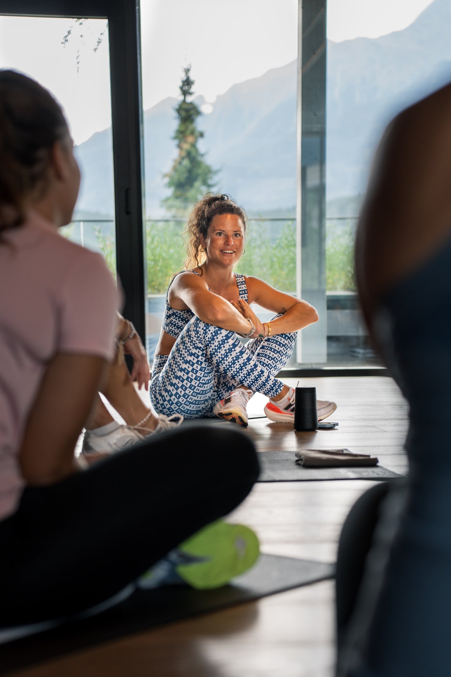 Eine Frau in Sportkleidung sitzt lächelnd im Fitnessstudio von Goldenbody Shop Ch.